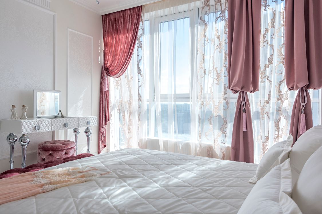 Sunlit drapery and curtains in a neatly made room