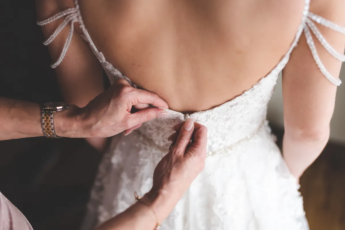 Close detail of an elegant white wedding gown
